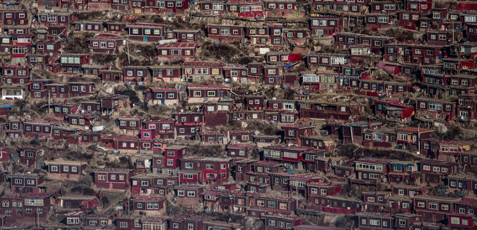 This picture taken on December 8, 2015 shows homes of Buddhist nuns and monks from the Larung Gar Buddhist Institute in Sertar county (known as Seda in Chinese) in the remote Garze Tibetan Autonomous Prefecture in southwest China's Sichuan province. The monastery founded in 1980 has become one of the largest and most influential centres for the study of Buddhism with up to 40,000 monks and nuns in residence for parts of the year. AFP PHOTO / FRED DUFOUR / AFP / FRED DUFOUR