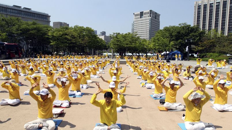 South Korean members of Falun Dafa, also known as Falun Gong, perform during a rally to commemorate "World Falun Dafa Day," which falls on May 13, in Seoul, South Korea, Sunday, May 10, 2015. More than 500 practitioners attending Sunday's rally denounced the Chinese government's alleged policy of harassment and torture of Falun Dafa members in China. (AP Photo/Ahn Young-joon)